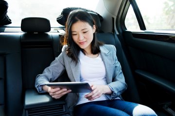 woman in a car traveling for business