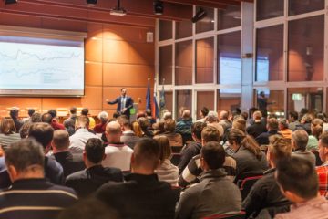 View from behind at conference meetings attended by a large number of people