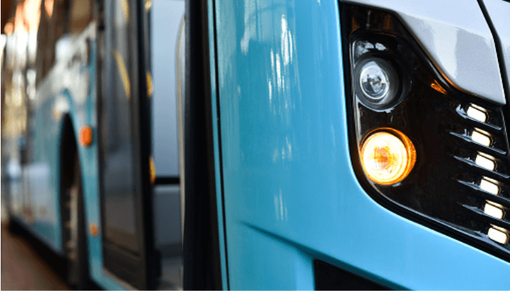 A close up of the front of a blue bus at JFK Airport.