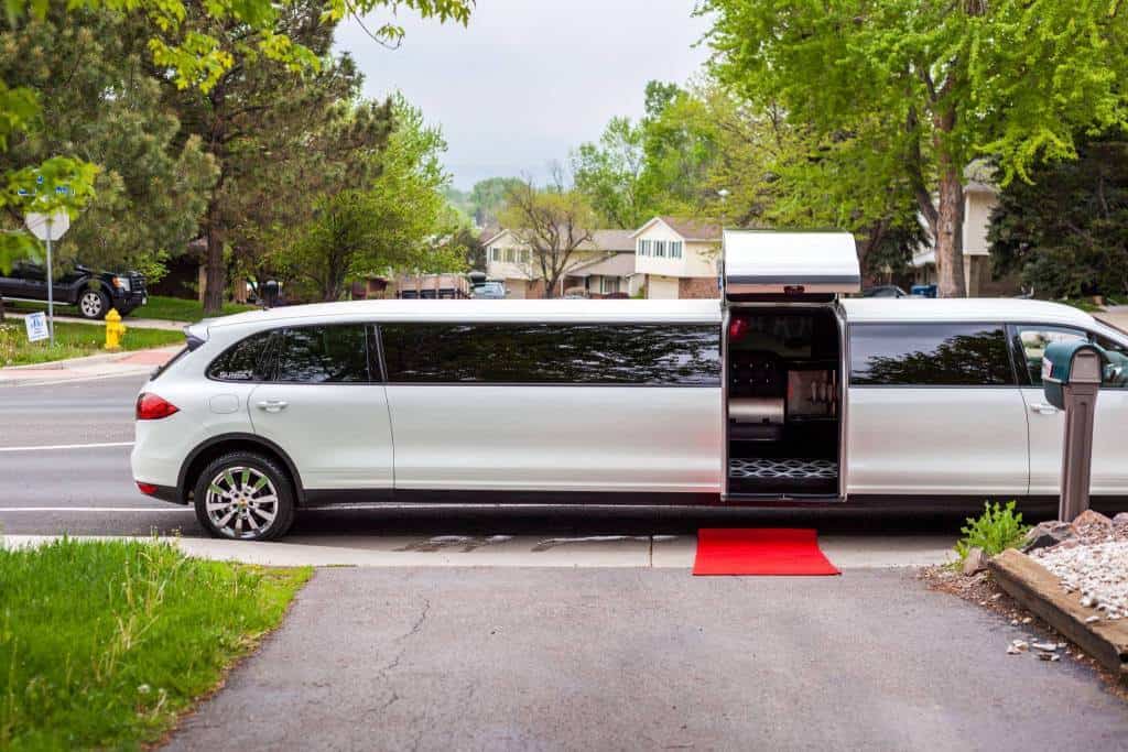 A Mercedes-Benz stretch limo parked on a street, offering airport transfer services.
