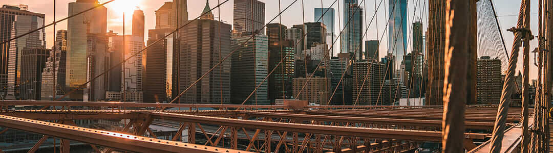The brooklyn bridge in new york city at sunset.