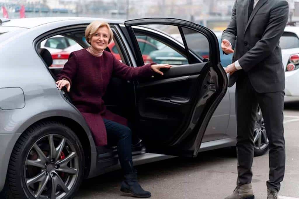 A couple standing beside a car in New York.