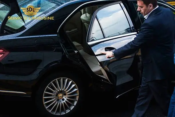 A man is getting out of a Sonic D Limousine black Mercedes-Benz in Hackensack, NJ. Sonic D Limousine is the premier transportation provider in Hackensack, New Jersey.