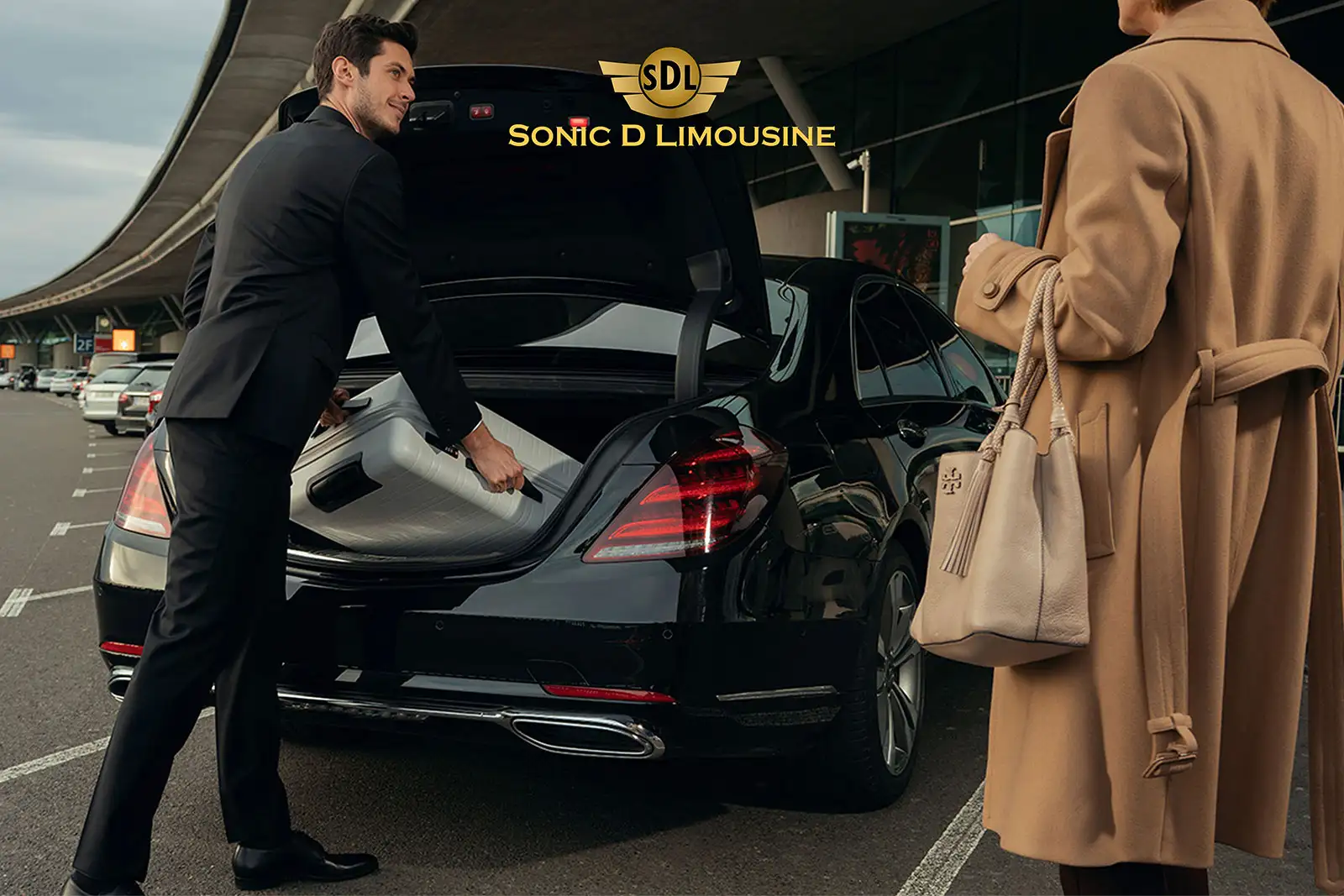 Sonic D Limousine A man and woman are loading their luggage into a mercedes benz.