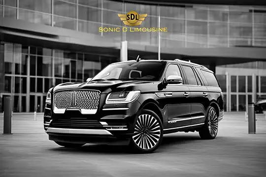 Sonic D Limousine Worldwide Voted Most Reliable Airport Transportation Provider! A black luxury SUV with chrome detailing is parked in front of a modern building with large glass windows. The logo "SDL Sonic D Limousine Luxury Airport Transportation" is displayed above the vehicle. Sonic D Limousine Worldwide your luxury Airport Transportation