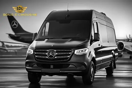 Sonic D Limousine Worldwide Voted Most Reliable Airport Transportation Provider! Black Mercedes-Benz Sprinter van parked on an airport tarmac with SDL Sonic D Limousine logo and airplane in the background, showcasing luxury airport transportation. Sonic D Limousine Worldwide your luxury Airport Transportation