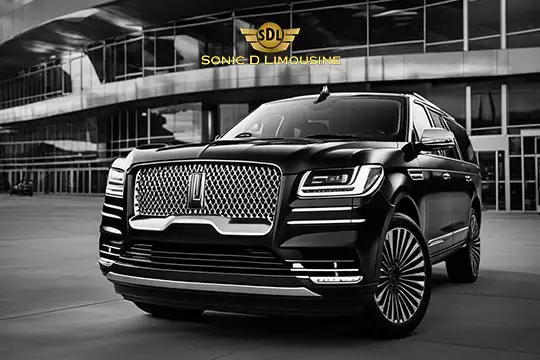 Sonic D Limousine Worldwide Voted Most Reliable Airport Transportation Provider! Black luxury SUV with chrome detailing, parked outside a modern building. "Sonic D Limousine Luxury Airport Transportation" logo displayed above. Sonic D Limousine Worldwide your luxury Airport Transportation