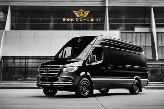 Sonic D Limousine Worldwide Voted Most Reliable Airport Transportation Provider! A sleek black Mercedes-Benz van, featuring the "Sonic D Limousine" logo, is parked in front of a modern building. This luxurious vehicle is ready to provide top-tier luxury airport transportation for discerning travelers. Sonic D Limousine Worldwide your luxury Airport Transportation