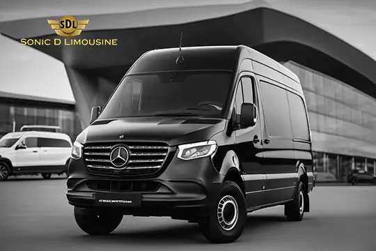 Sonic D Limousine Worldwide Voted Most Reliable Airport Transportation Provider! Black Mercedes-Benz van for Sonic D Limousine Luxury Airport Transportation in front of a modern building. Sonic D Limousine Worldwide your luxury Airport Transportation