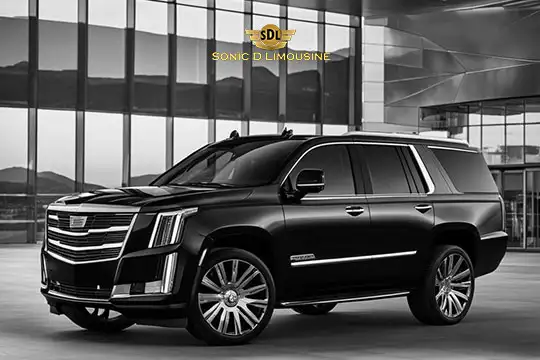 Sonic D Limousine Worldwide Voted Most Reliable Airport Transportation Provider! A sleek black luxury SUV parked in front of a modern building proudly displays the Sonic D Limousine Luxury Airport Transportation logo above it. Sonic D Limousine Worldwide your luxury Airport Transportation