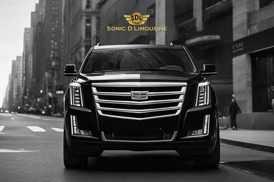 Sonic D Limousine Worldwide Voted Most Reliable Airport Transportation Provider! A black luxury SUV with a prominent front grille and LED headlights is parked in an urban setting, featuring the "Sonic D Limousine Luxury Airport Transportation" logo and text at the top. Sonic D Limousine Worldwide your luxury Airport Transportation